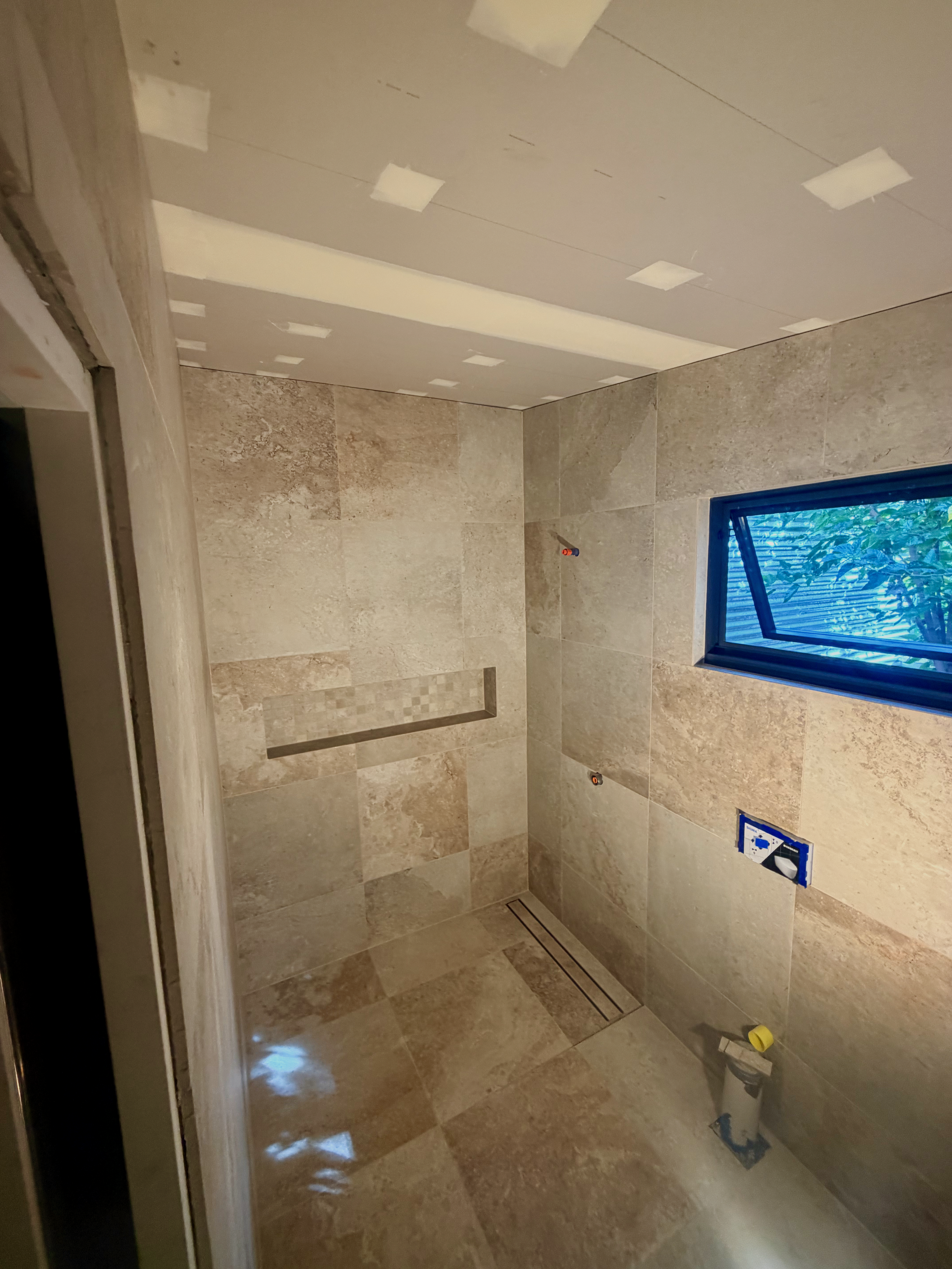 Elegant tile installation with natural stone effect and warm tones